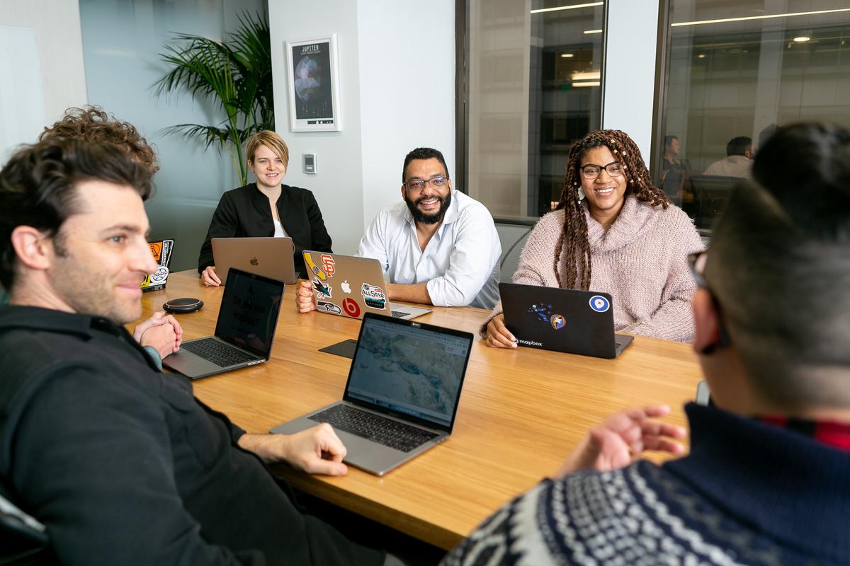 A group of office workers at their desks, representing understanding employee attendance policy