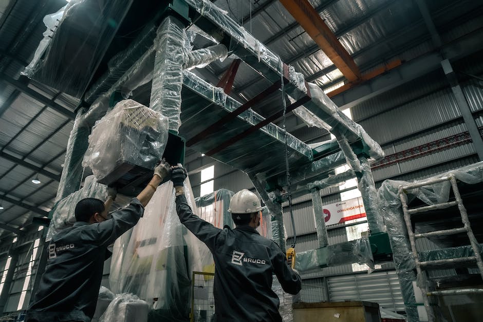 A group of warehouse workers in a busy warehouse, handling inventory and operating machinery, representing career advancement opportunities in warehouse supervision.