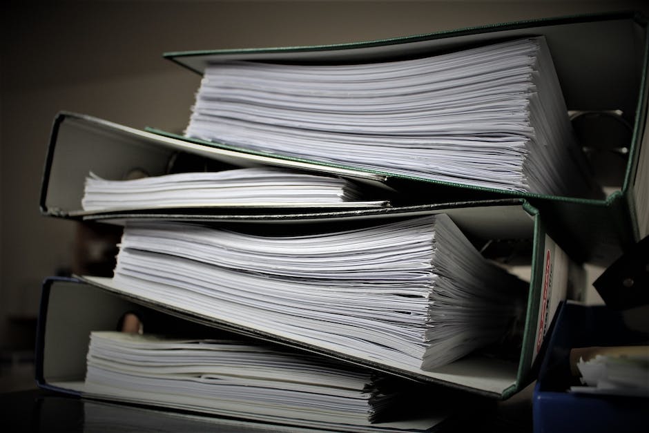 Image of a person working in an HR office, organizing files and documents.