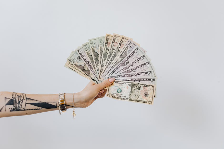 Image illustrating negotiation tactics for better pay, depicting a person shaking hands with a pile of money in the background.