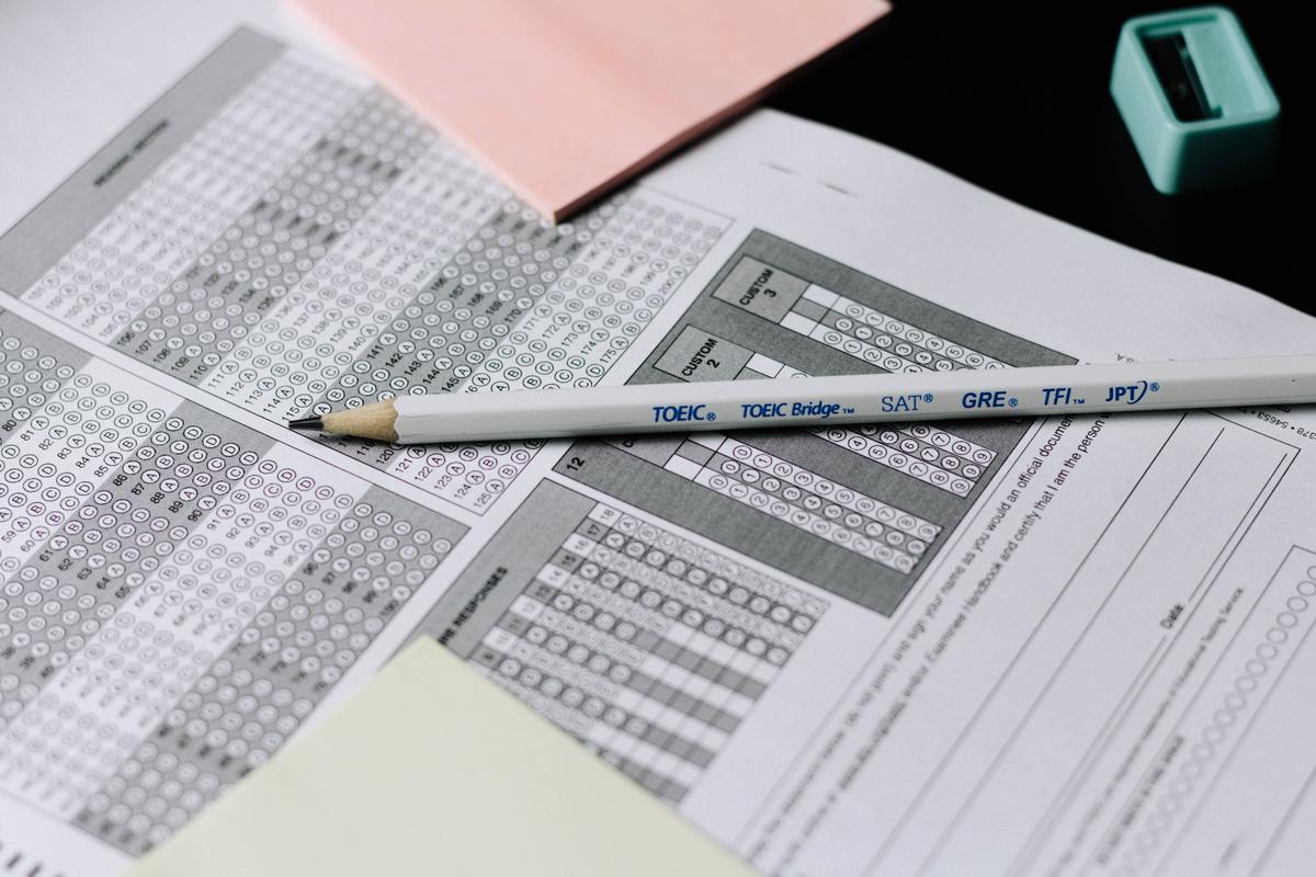 Illustration showing a person taking a personality test with a pencil and answer sheet.
