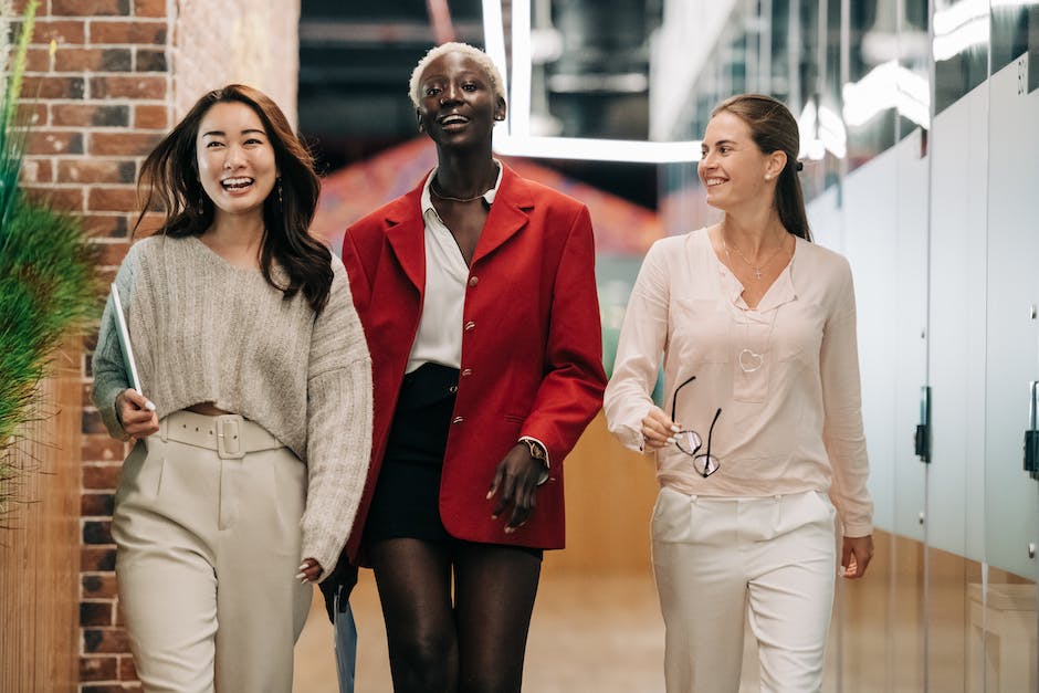 Image of a group of diverse people working happily in an office environment