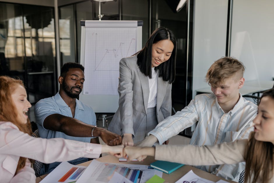 Image depicting a diverse group of employees working together in an office environment